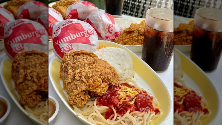 Jollibee fried chicken, a burger, and spaghetti with white rice and a soda