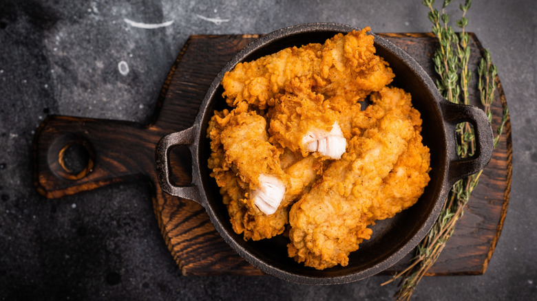 Fried chicken fillet strips in a pot