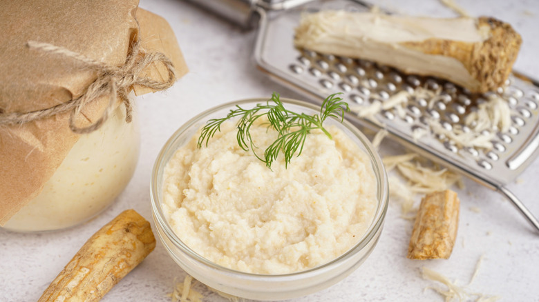 Bowl of horseradish with grater and