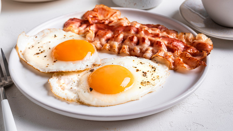 bacon and eggs on a white plate