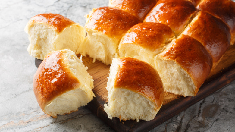 Dinner rolls on wooden board