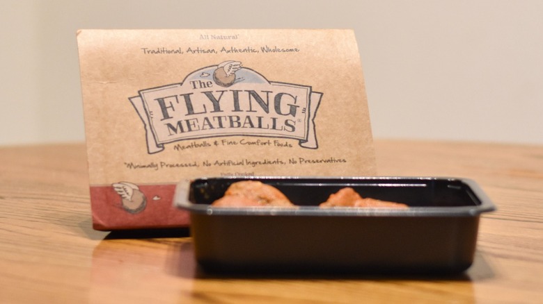 A package of The Flying Meatballs next to a prepared tray of meatballs