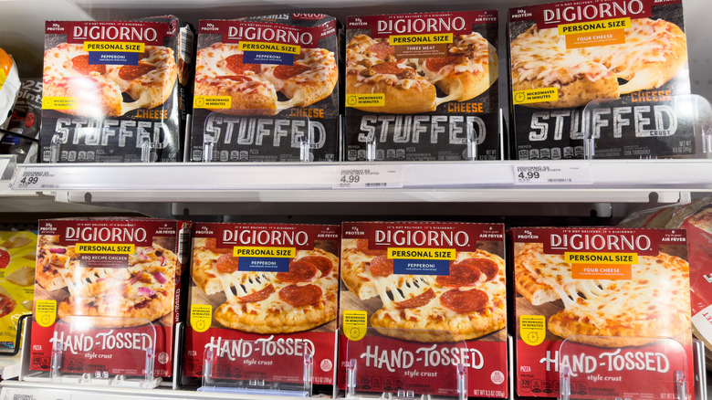 Boxes of DiGiorno pizza in a grocery store freezer