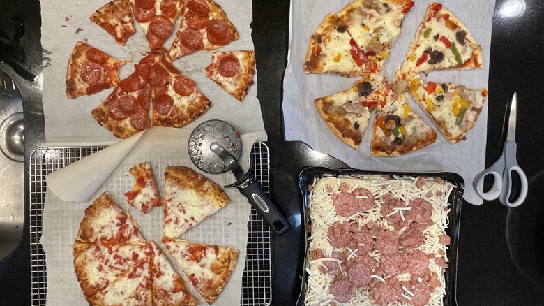 Four pizzas being tasted