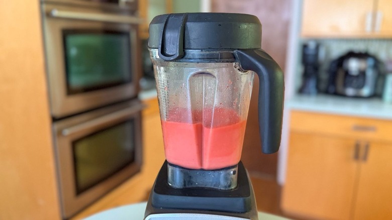 Frozen strawberry daiquiri mixture in blender pitcher on high speed