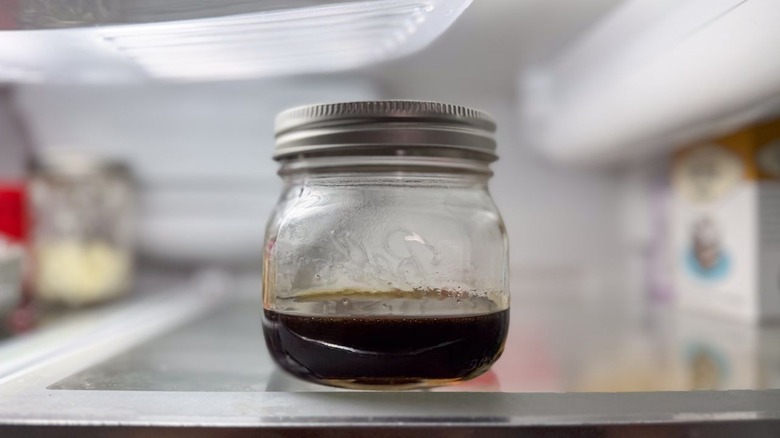 Turbinado sugar syrup in glass jar in refrigerator
