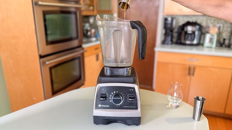 Pouring turbinado sugar syrup into blender pitcher