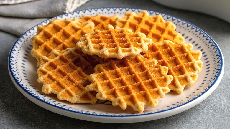 Plain waffles on a white plate with blue trim