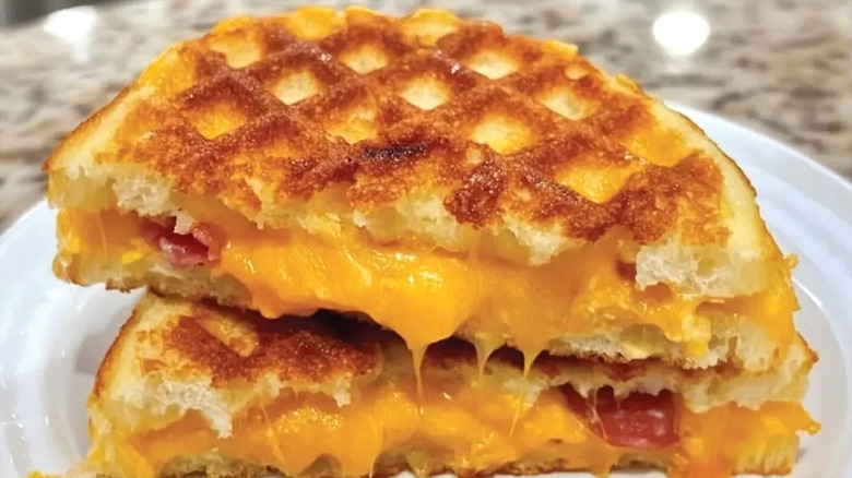 Halved frozen waffle grilled cheese sandwich on a white plate