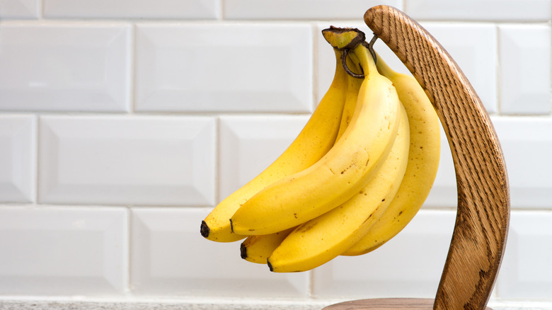 Bananas on banana hanger on kitchen counter