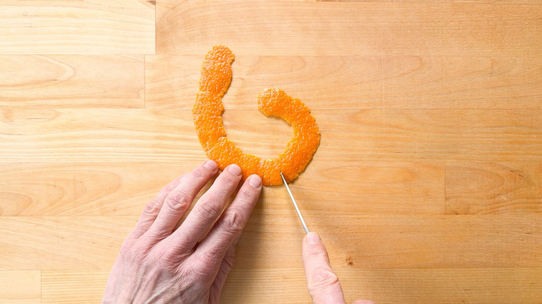 Cutting small slits in blood orange zest strip