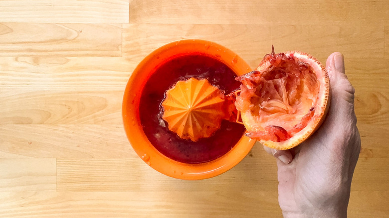 Juicing blood oranges by hand