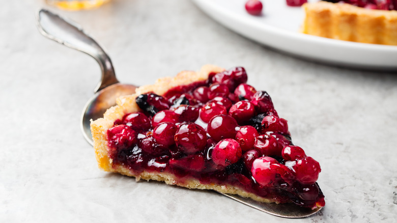 slice of cherry pie on a pie cutter