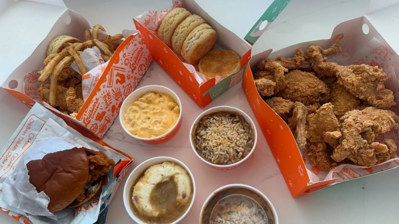 Variety of Popeyes menu items on white table.