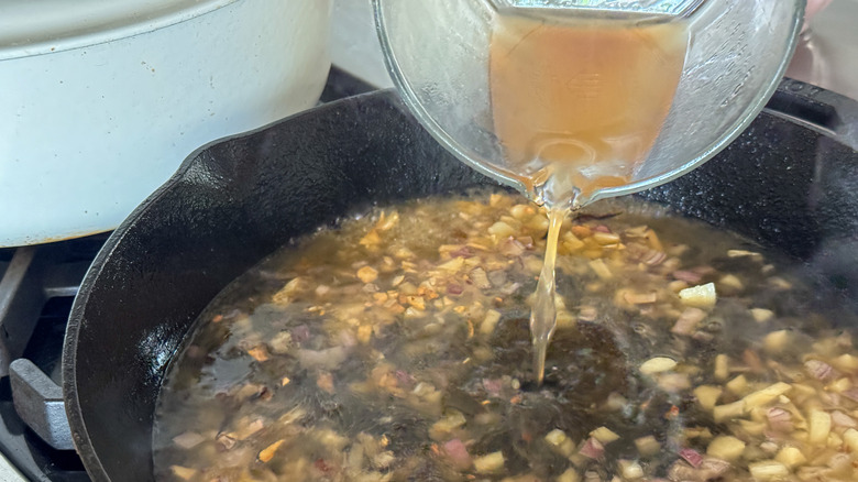 pouring broth in pan