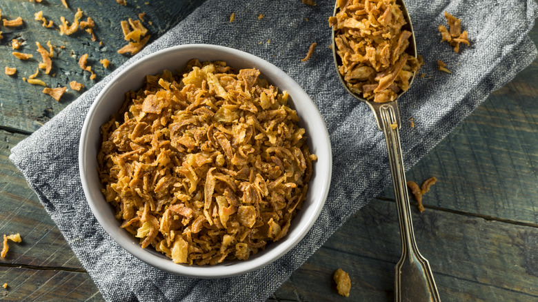 A bowl of crispy fried onions is photographed from above.