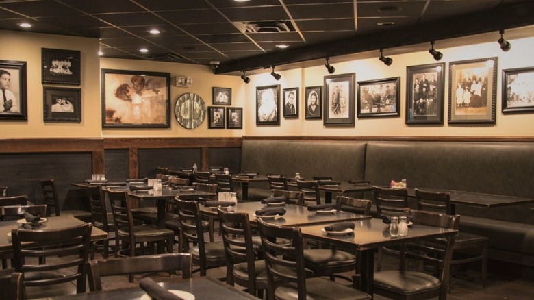 Interior of Garozzo's restaurant with empty seats and old photos hanging on the wall to showcase its history.