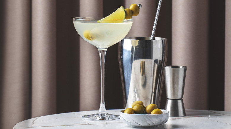 Martini in a glass with a cocktail shaker on the side