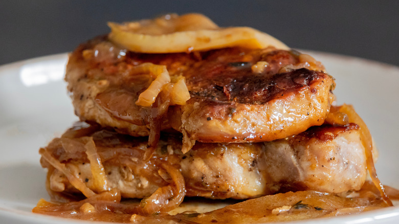 Pork chops stacked with onions and apples