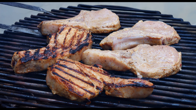 Smoking and grilling pork chops outside on a BBQ