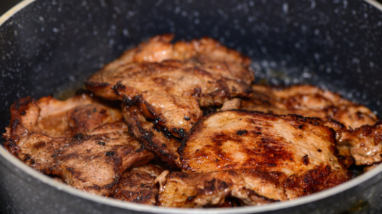 Searing pork chops in a skillet