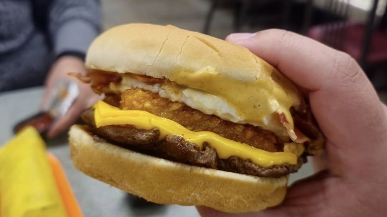 Hand holding a Whataburger Breakfast Burger.