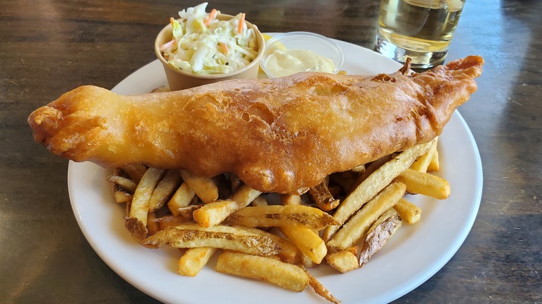 Crispy fish filet on top of a pile of french fries