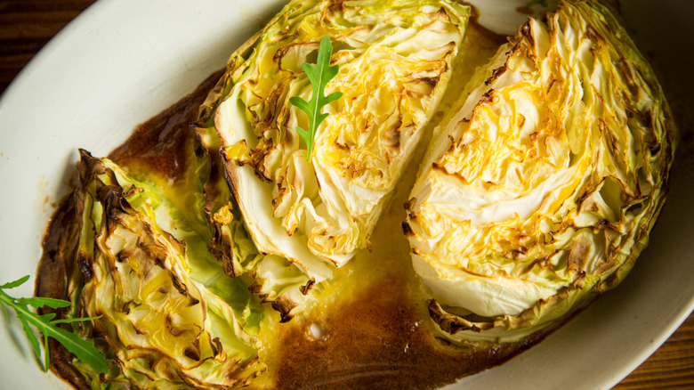 Young early cabbage baked in pieces in the oven, in a ceramic form.