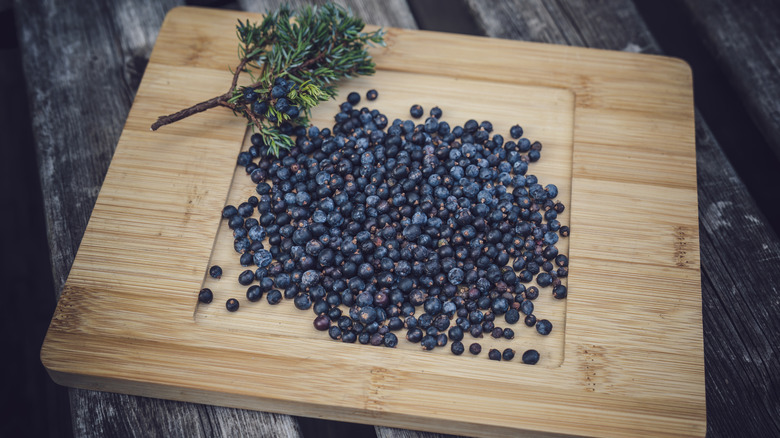 Juniper berries on a wooden board.