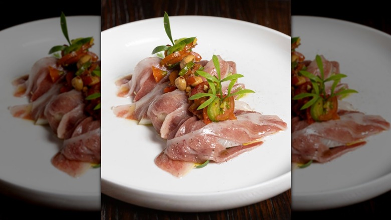 prosciutto and tomatoes on a plate