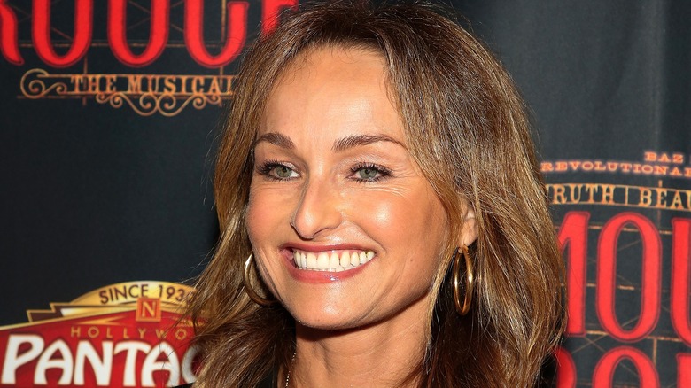 Giada de Laurentiis smiling in gold hoop earrings