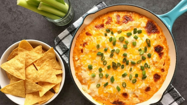 Baked Buffalo chicken dip in a teal pan.