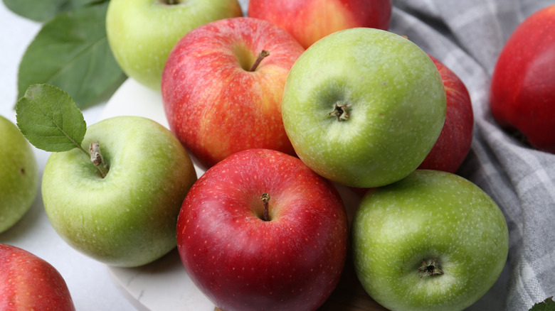 Close up of red and green apples on a table