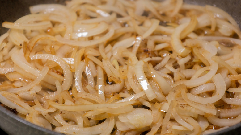 Caramelized onions cooking in a frying pan