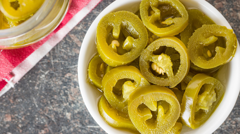 Close up of pickled jalapenos in a white bowl