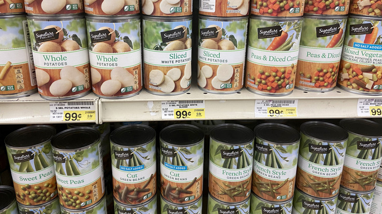 A variety of Signature Select canned vegetables displayed on a store shelf