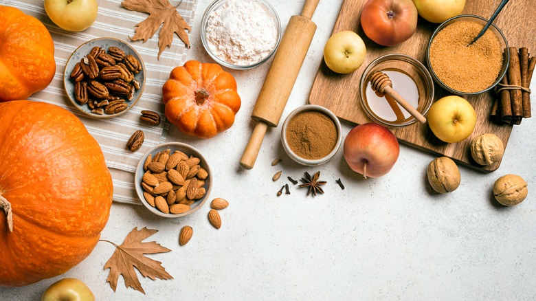 Ingredients to create a pumpkin recipe include the gourd, plus nuts, flour, and cinnamon.