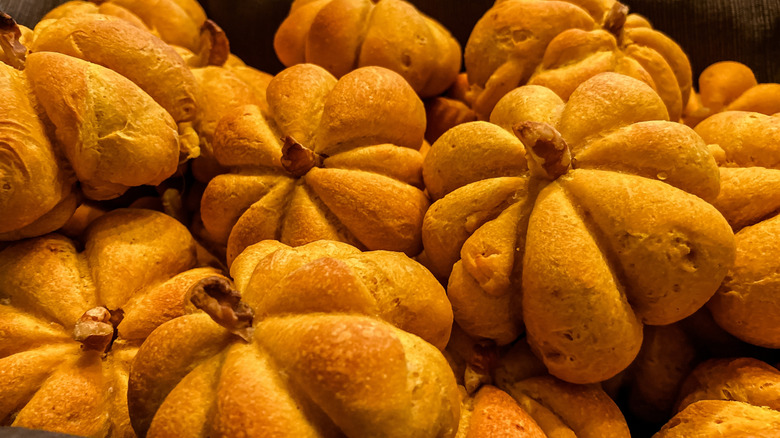 pile of pumpkin-shaped bread rolls