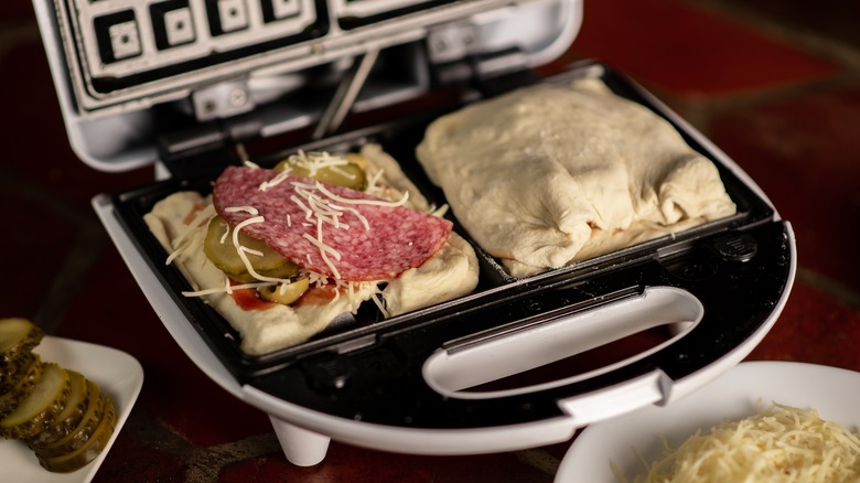 Pizza ingredients in waffle iron