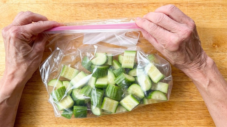 Cucumber slices in ziplock bag on cutting board
