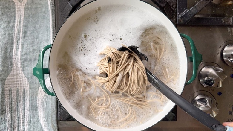 Soba noodles cooking in pot on stovetop