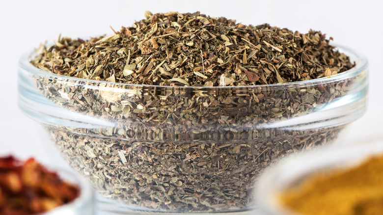 Glass bowl of Italian seasoning mix.