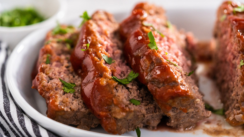 Sliced meatloaf in a dish.