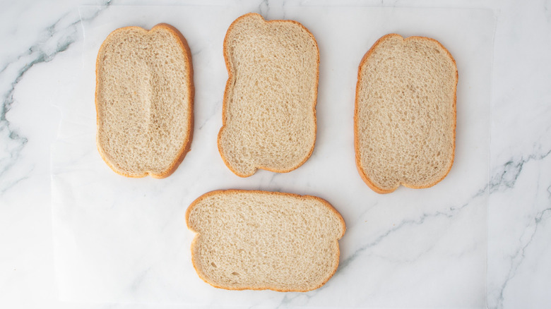 Bread slices on wax paper