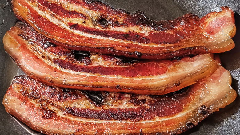 Crispy and crunchy thick-cut bacon in a pan