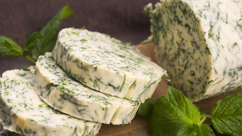 butter slices with fresh green herbs