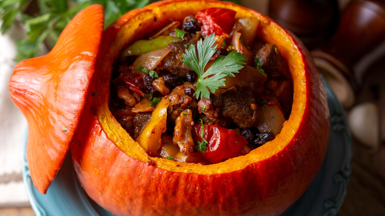 Beef stew or pot roast in an open roasted pumpkin.