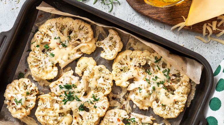prepped cauliflower steaks on a baking sheet