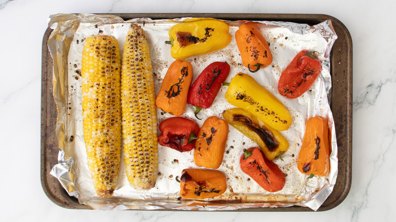 assorted roasted vegetables on foil-lined baking sheet