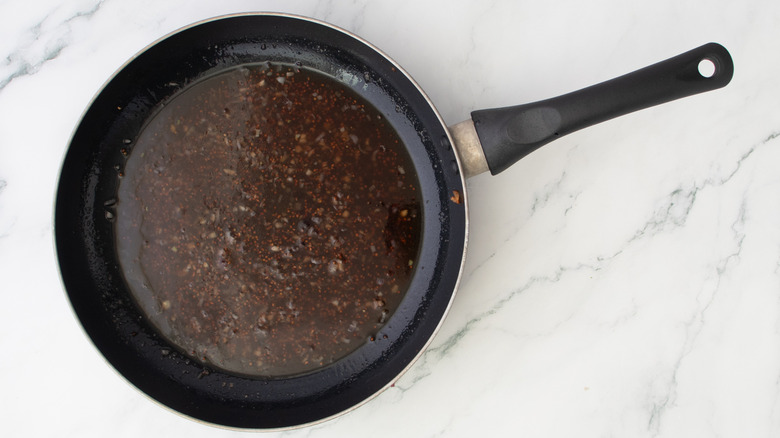 raspberry mustard dressing in skillet on top of marble surface